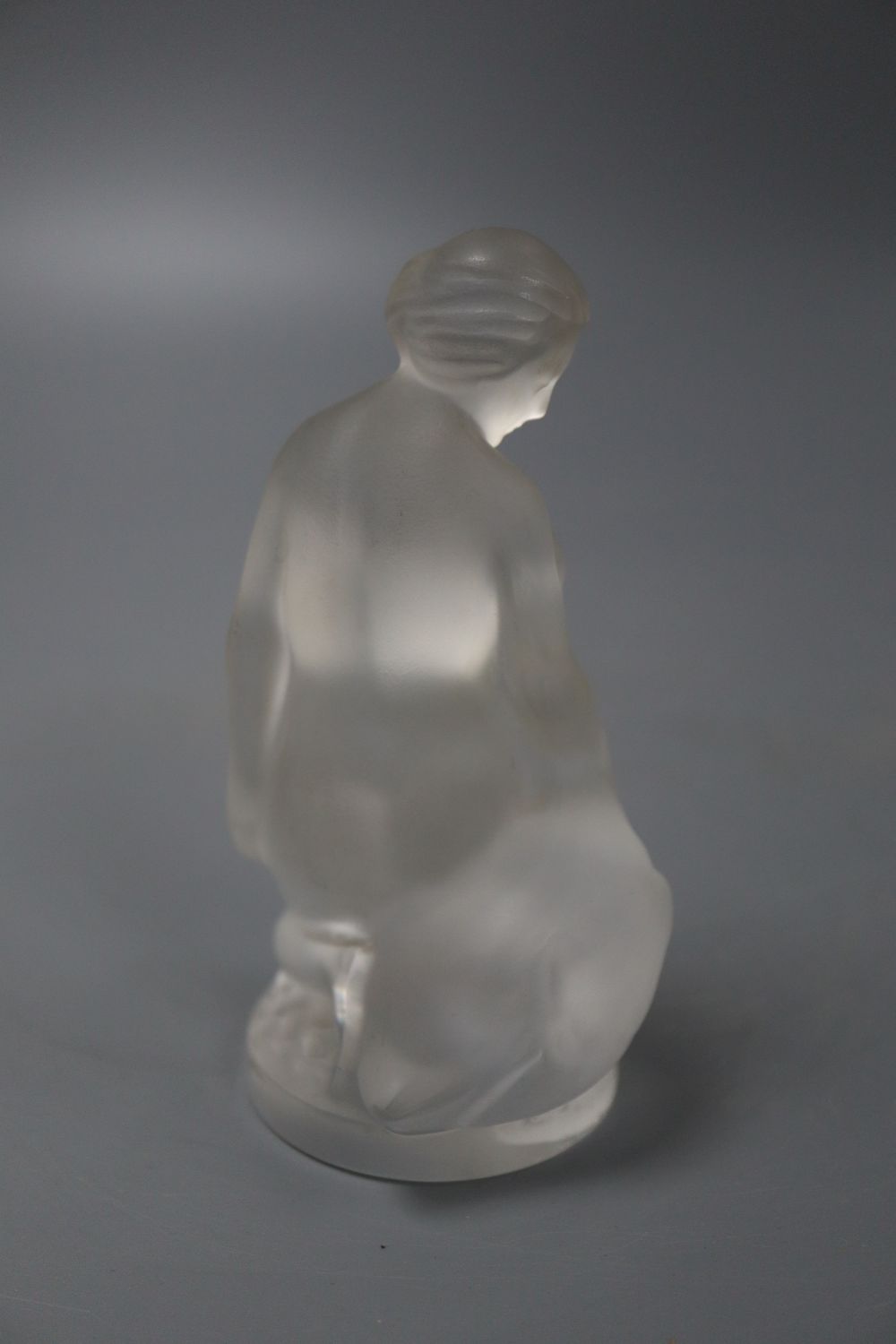 A Lalique figure of a lady and a swan, height 12cm